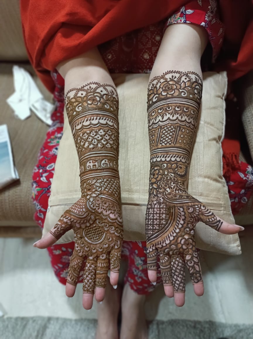 Full bridal mehndi on both hands with rose, jaali and elephant motifs