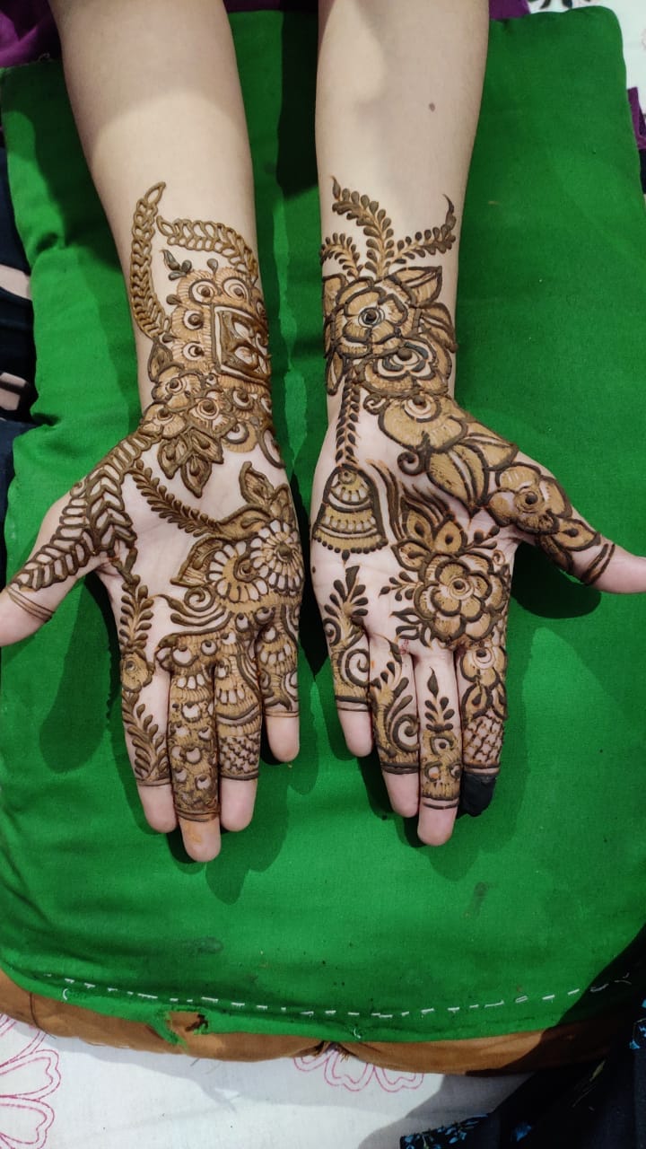 Arabic mehndi on both hands with bold florals and flowing vines