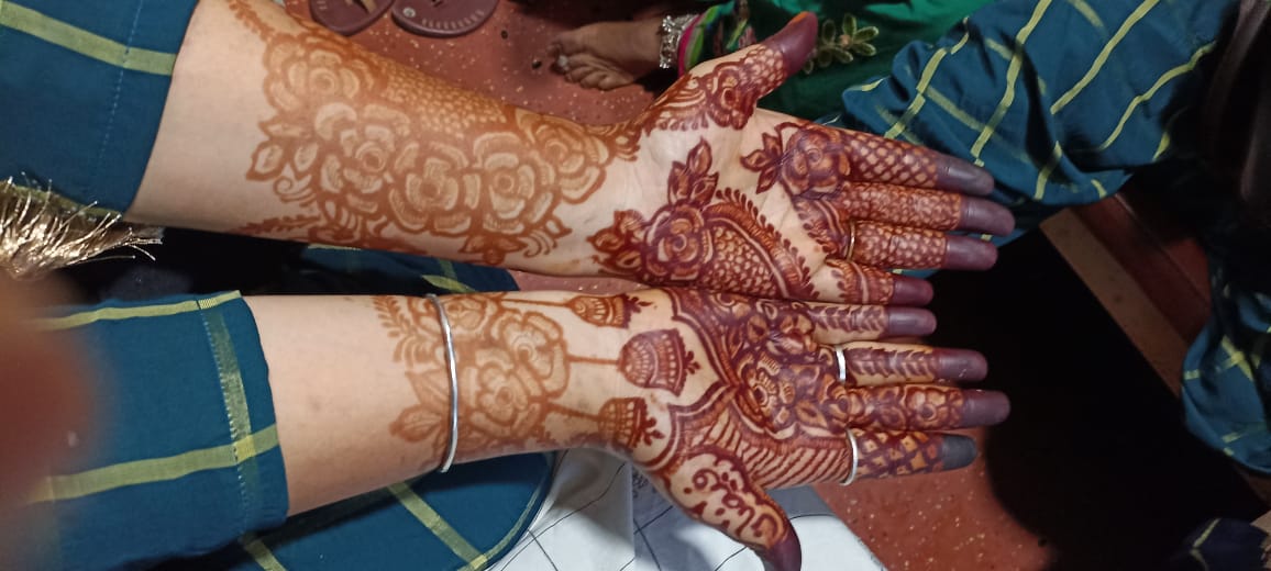 Indo Arabic mehndi with rose and jhumka motifs on hands and wrists